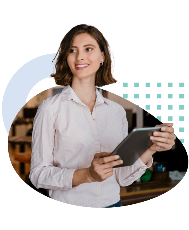 Photo of a woman smiling while holding a tablet