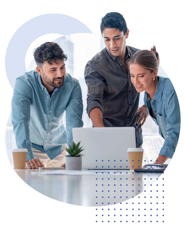 Photo of three people in an office setting looking at a laptop screen