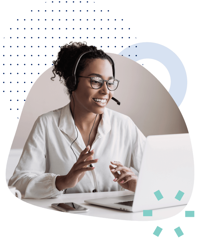 Woman with a headset speaking while looking at a laptop