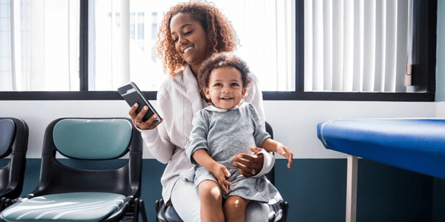 Woman holding phone and child